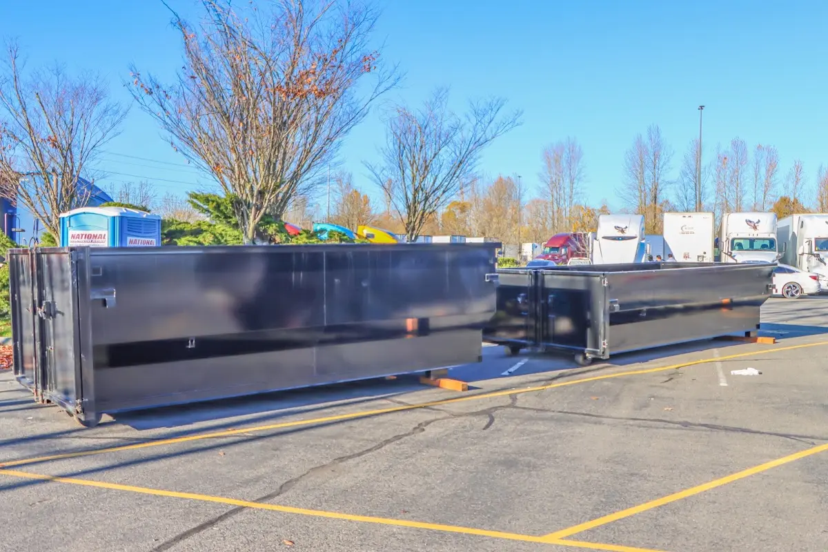 Professional dumpster rental service with roll-off container on residential driveway in Waukegan